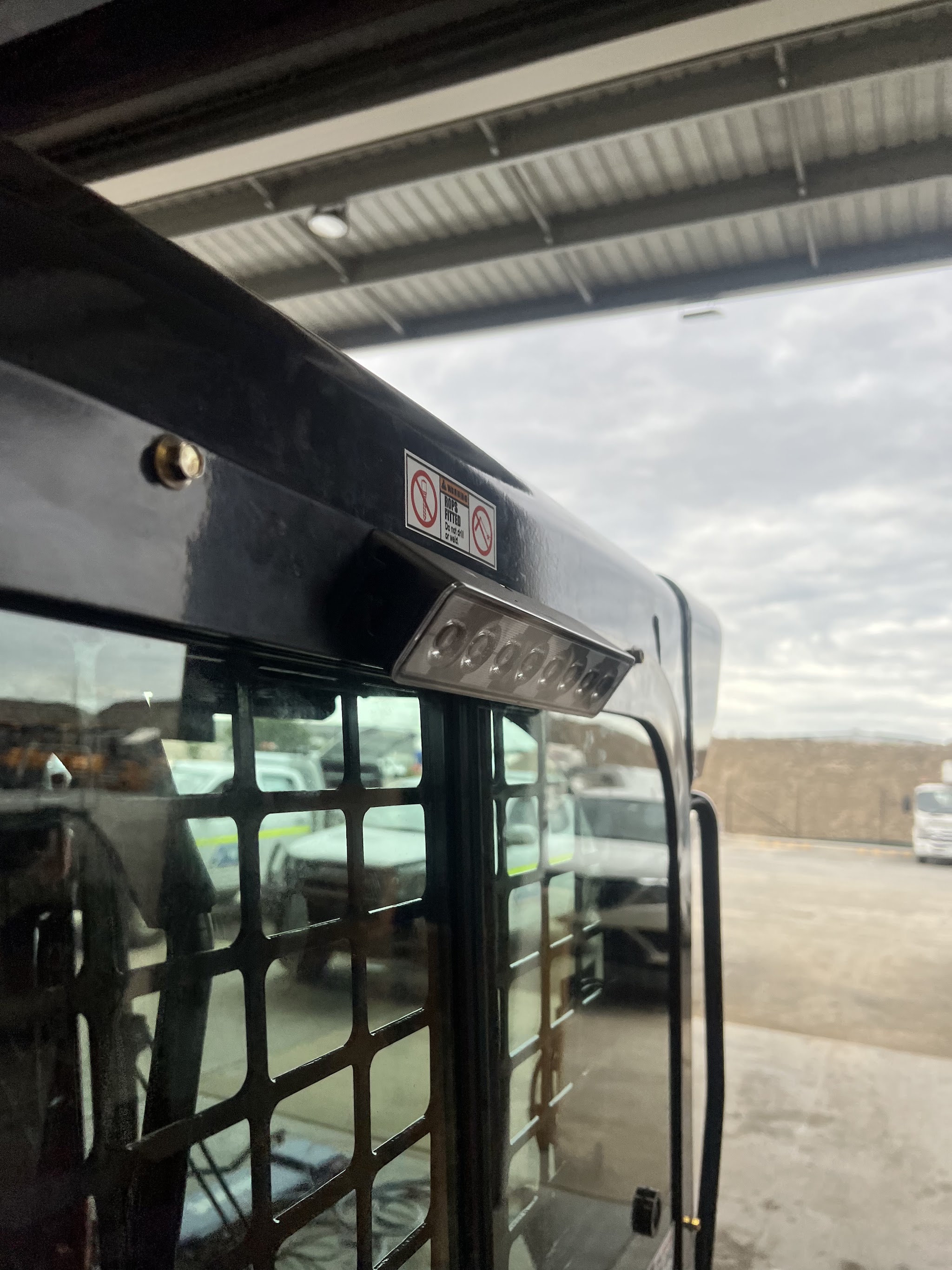 A close-up of an LED work light fitted to a machine canopy