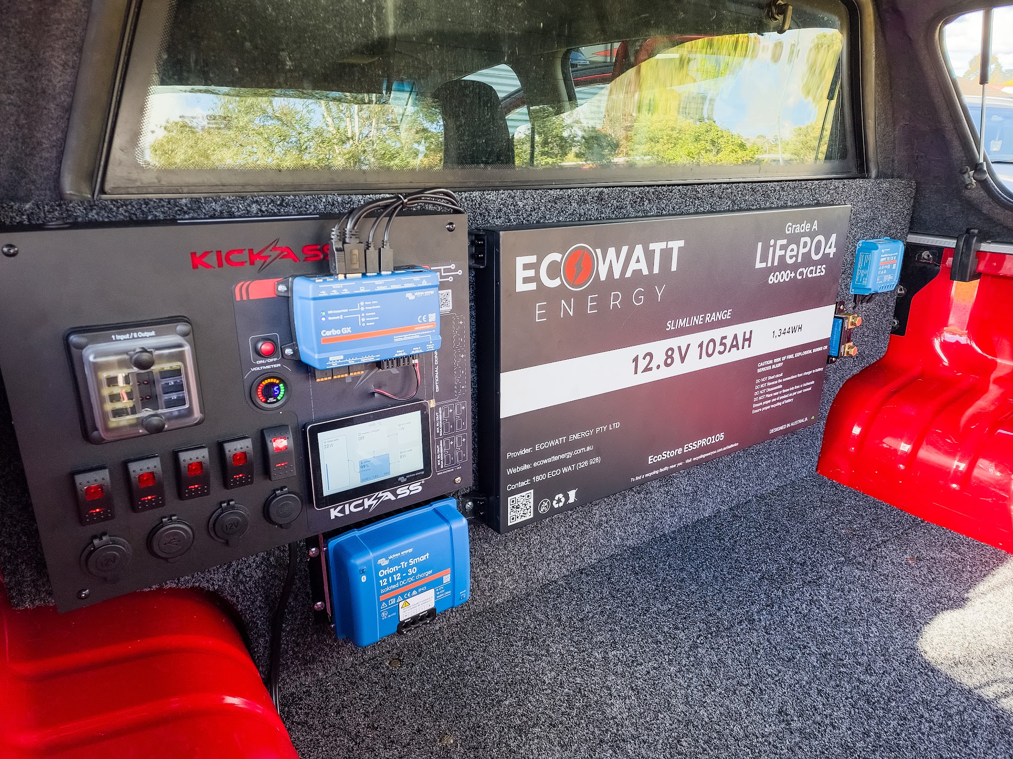A finished 12 volt fitout in the back of a ute canopy, with a switch panel, DC-DC charger, solar controller and lithium battery